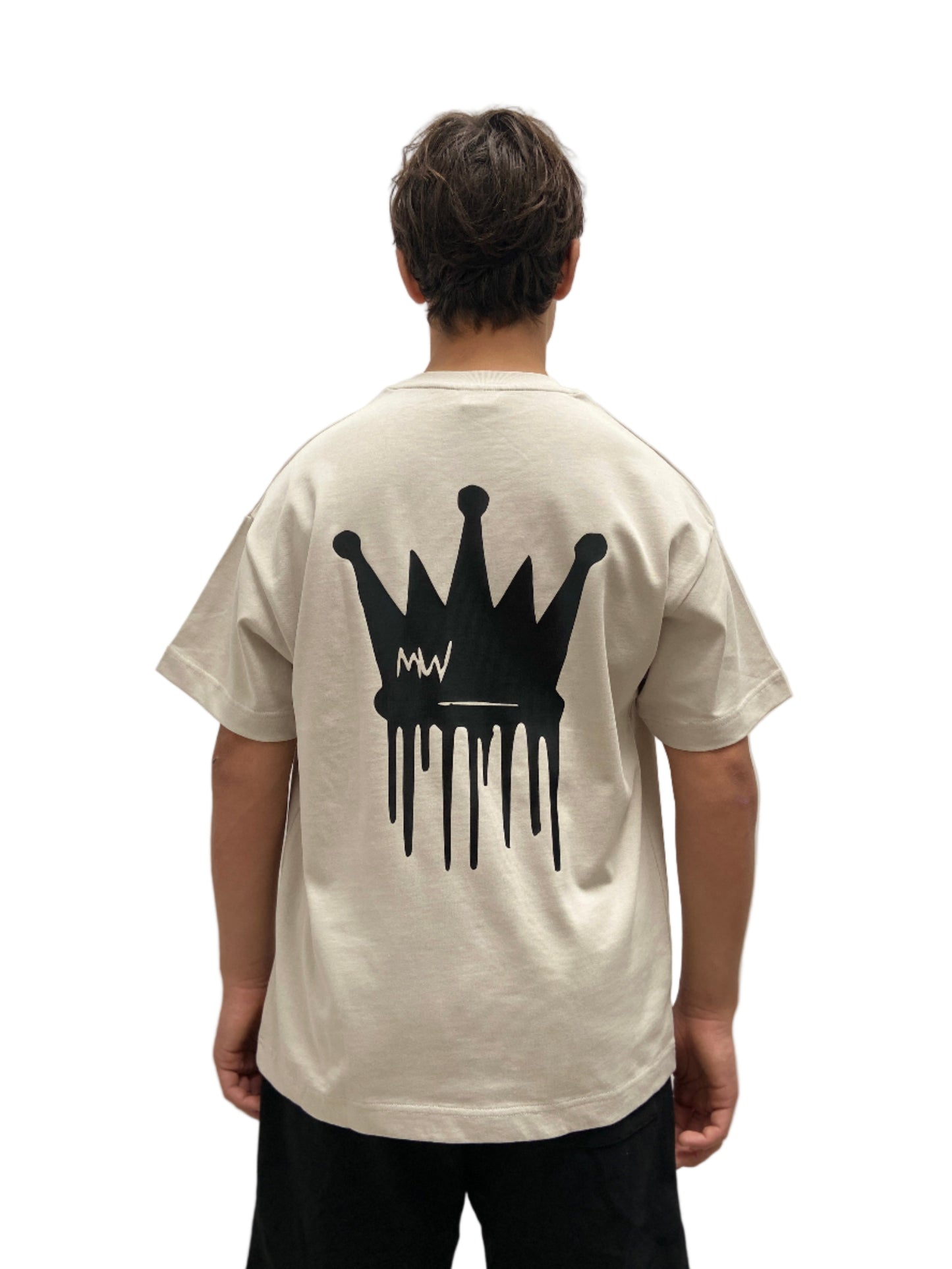 Person wearing a beige t-shirt with a black crown graphic on the back against a plain background