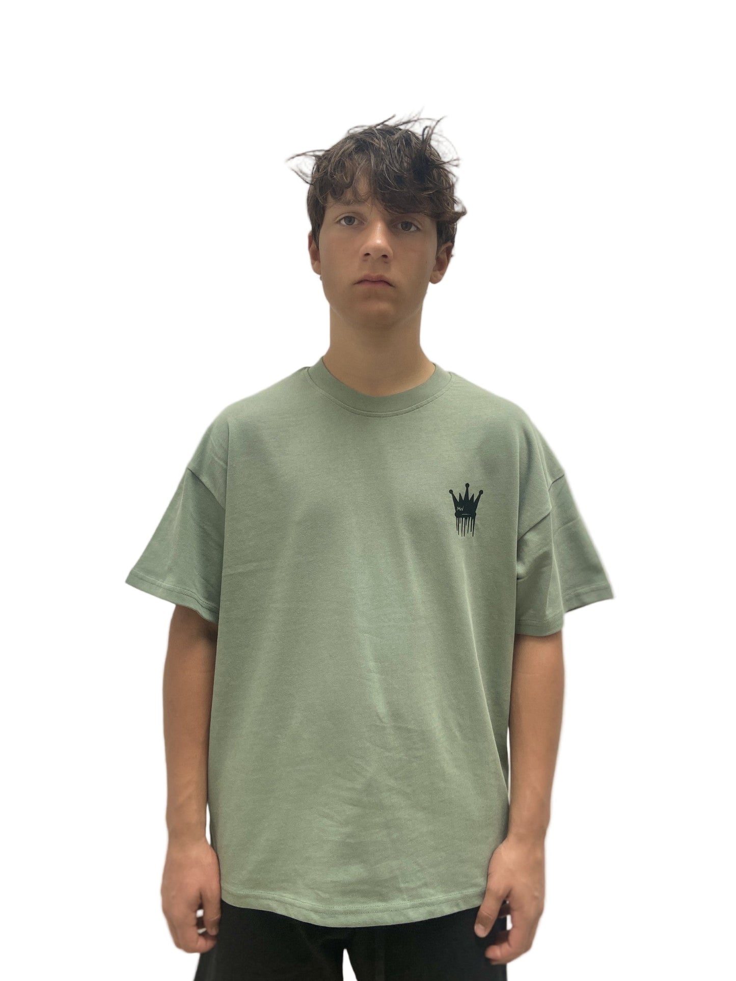 Person wearing a green t-shirt with a small logo on a white background