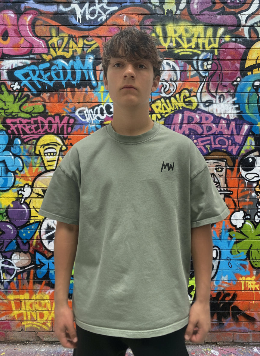 Trending streetwear Person wearing a green t-shirt with a logo on a plain background