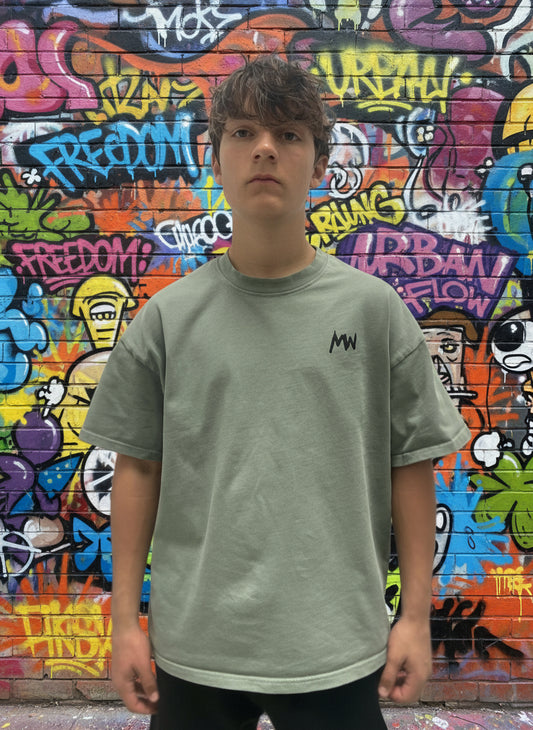 Trending streetwear Person wearing a green t-shirt with a logo on a plain background