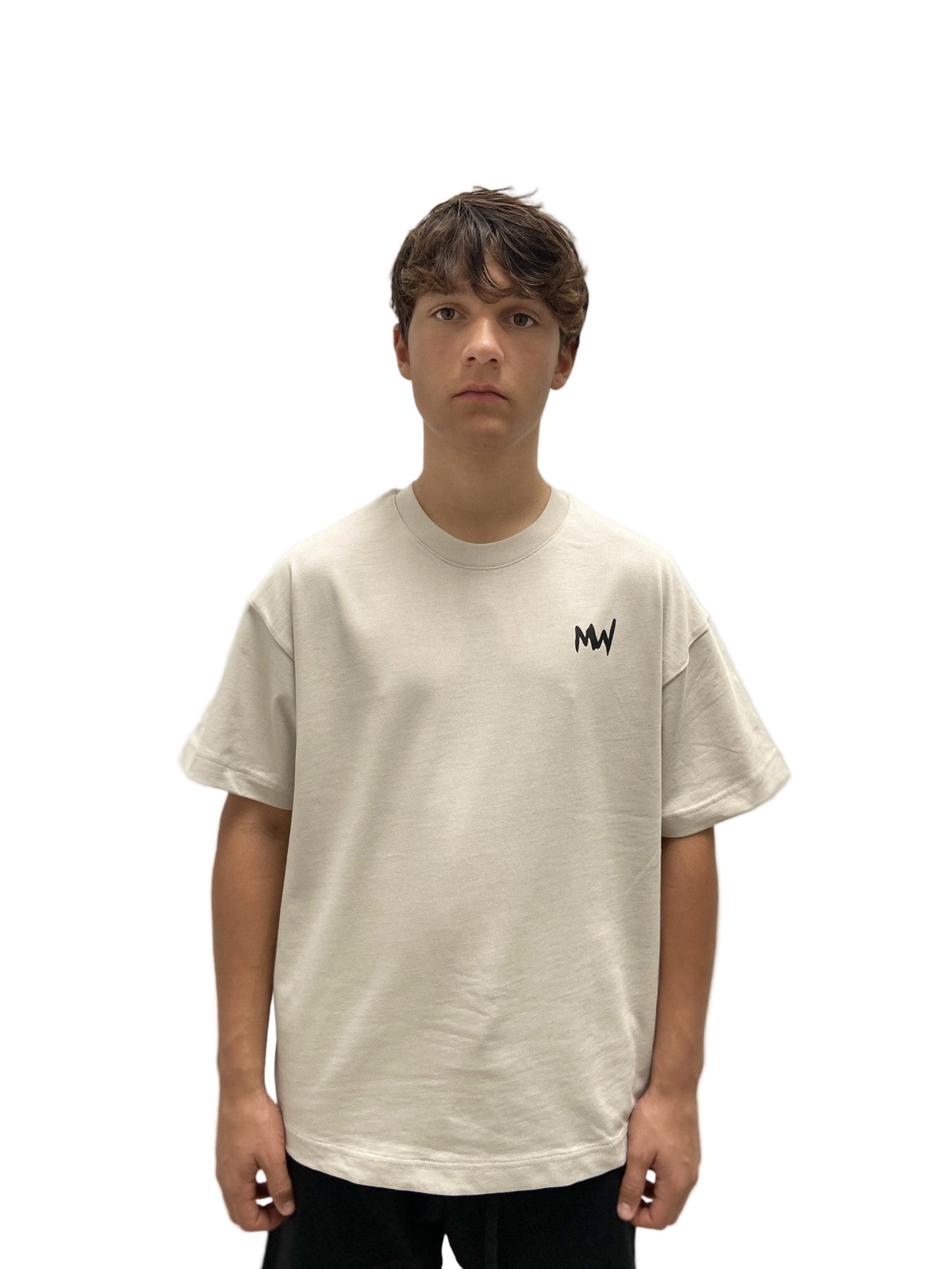 Streetwear latest trend Person wearing a beige t-shirt with a logo on a plain background