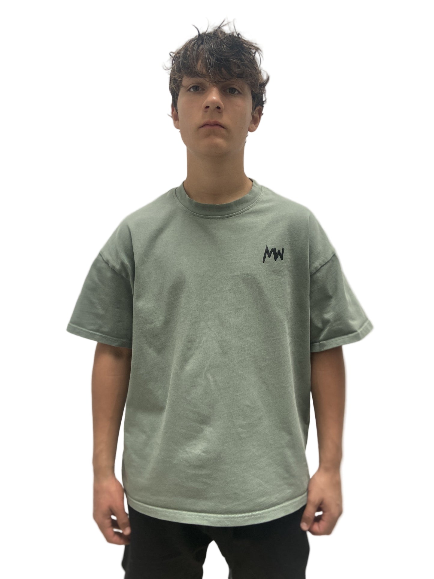Trendy streetwear Person wearing a green t-shirt with a logo on a plain background