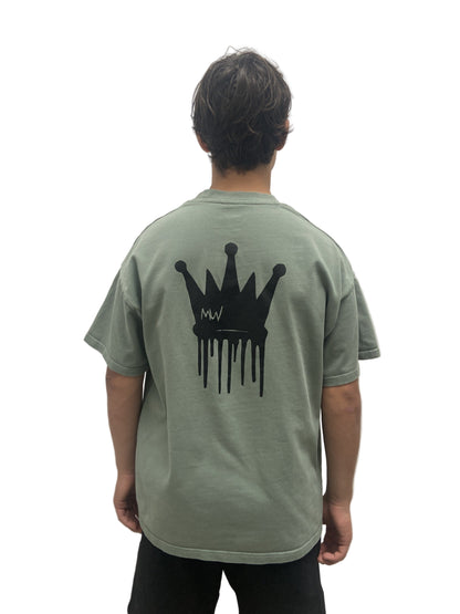Trending streetwear Person wearing a green t-shirt with a black crown design on the back against a plain background